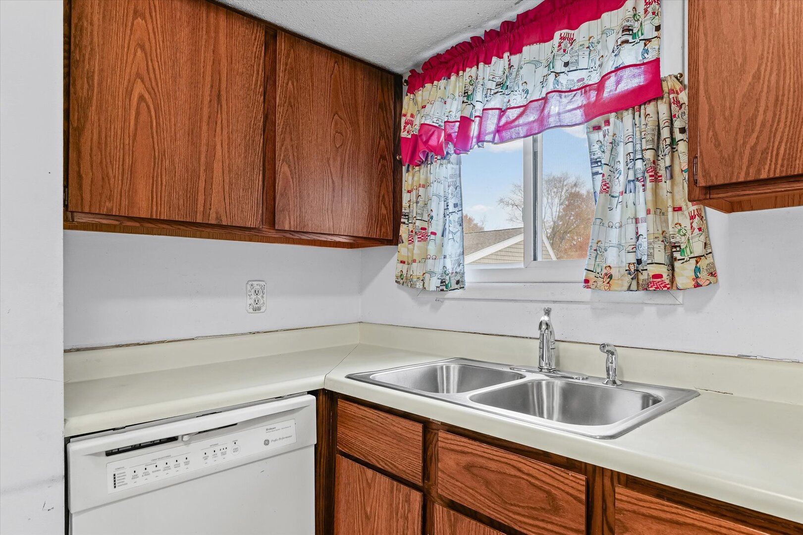 1928 Blackthorn Drive, Unit 1 Champaign, IL 61821 - Photo 13 of 28 a kitchen with a sink cabinets and window