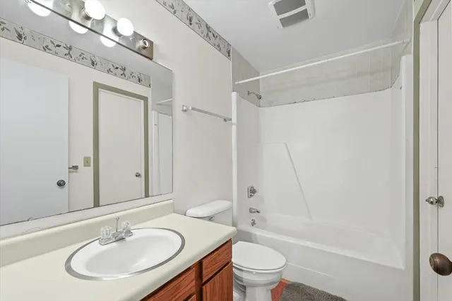 a bathroom with a sink toilet a mirror and shower