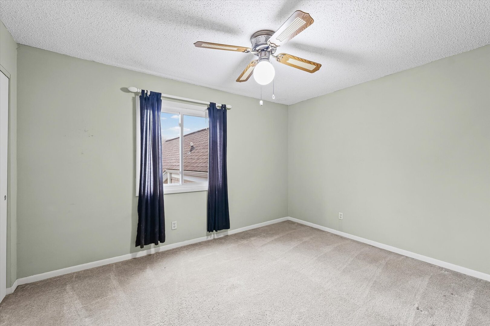 1928 Blackthorn Drive, Unit 1 Champaign, IL 61821 - Photo 20 of 28 an empty room with a chandelier fan and windows