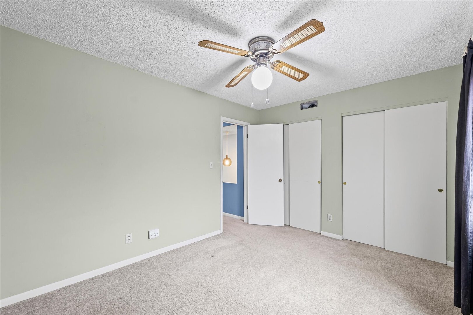 1928 Blackthorn Drive, Unit 1 Champaign, IL 61821 - Photo 21 of 28 a view of an empty room with a chandelier fan