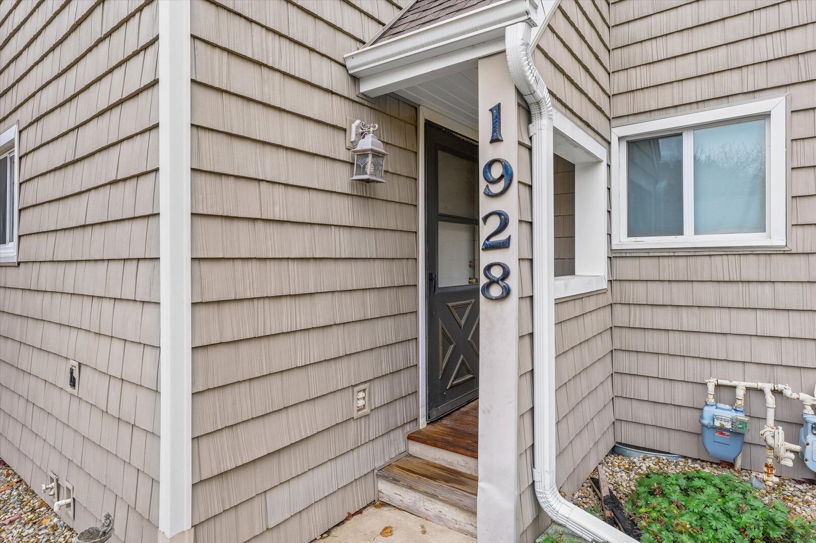 1928 Blackthorn Drive, Unit 1 Champaign, IL 61821 - Photo 4 of 28 a front view of a building with a garage