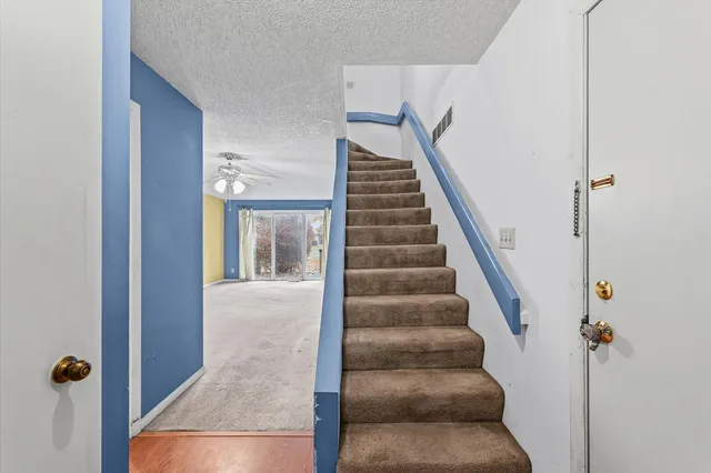 a view of staircase with white walls