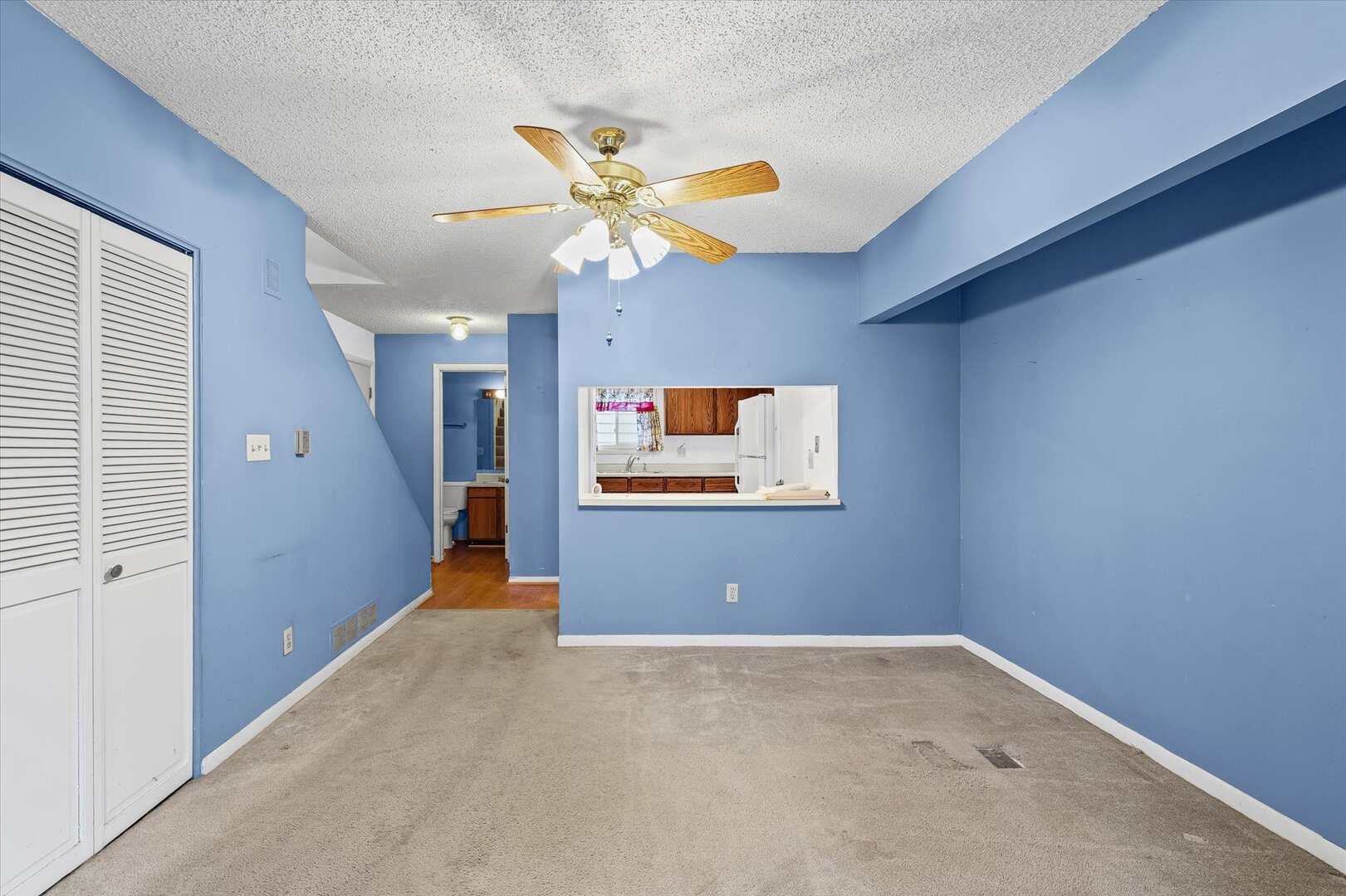1928 Blackthorn Drive, Unit 1 Champaign, IL 61821 - Photo 7 of 28 a view of a livingroom with a ceiling fan and window