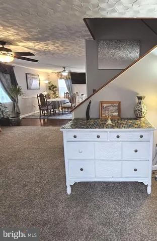a spacious bathroom with a granite countertop sink and a mirror