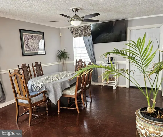 a dining room with furniture a chandelier and wooden floor
