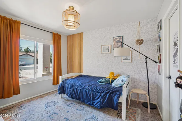 a bedroom with furniture and a window