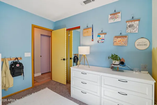 a bed room with a bed and a dresser