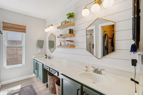 a bathroom with a sink double vanity granite and a mirror