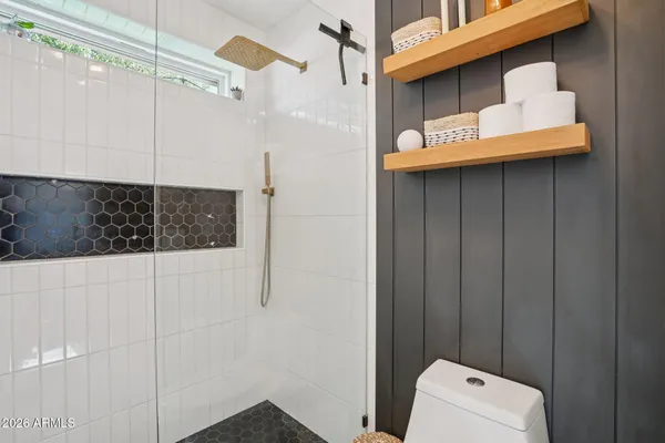 a bathroom with a shower and a sink