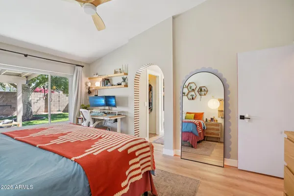a bedroom with a bed and a flat tv screen on the dresser