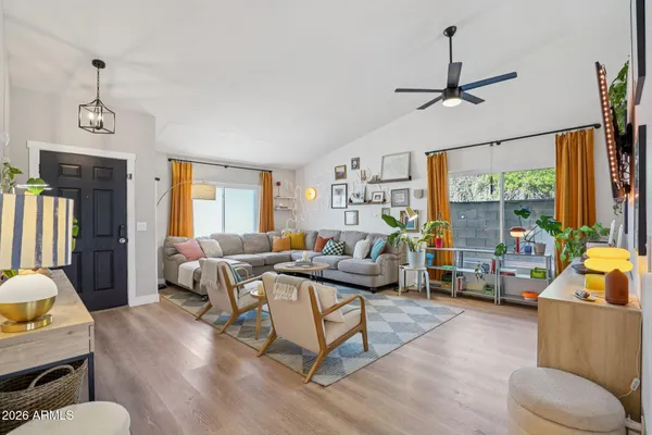 a living room with furniture a window and a flat screen tv