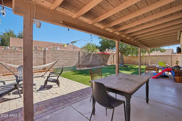 a view of a patio with a table chairs and a backyard