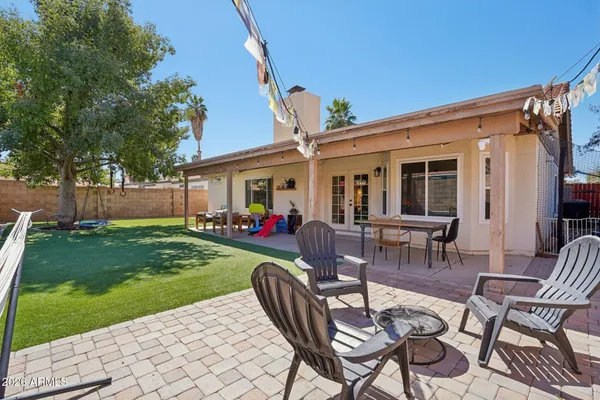 a view of a patio with a table and chairs