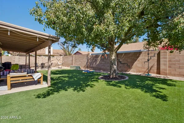 a view of a backyard with sitting area