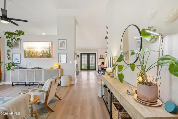 a living room with furniture flowerpot and wooden floor