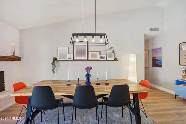 a dining room with furniture and wooden floor