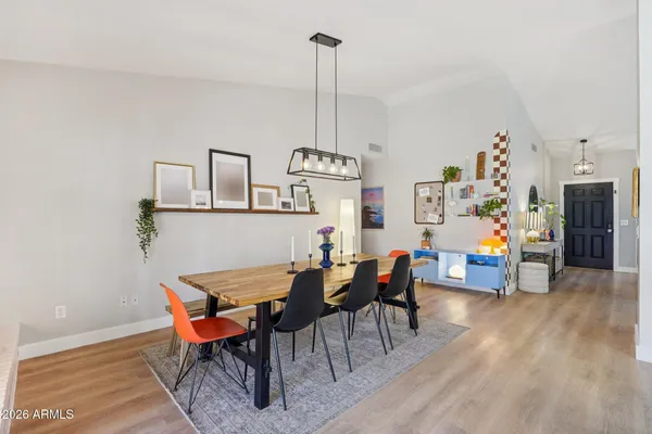 a view of livingroom and dining room with furniture wooden floor and a chandelier