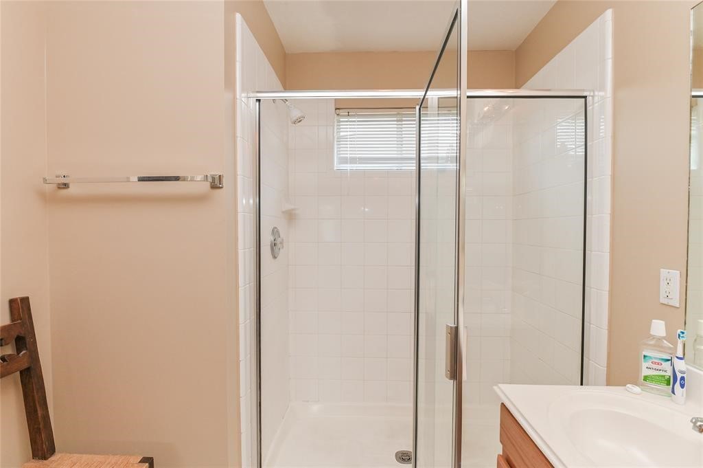 18446 South Wimbledon Drive Katy, TX 77449 - Photo 22 of 24 a bathroom with a shower and a sink