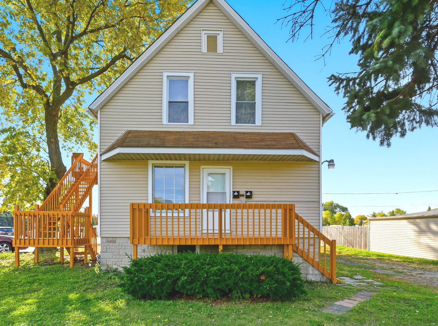 a view of a house with a yard and a garden