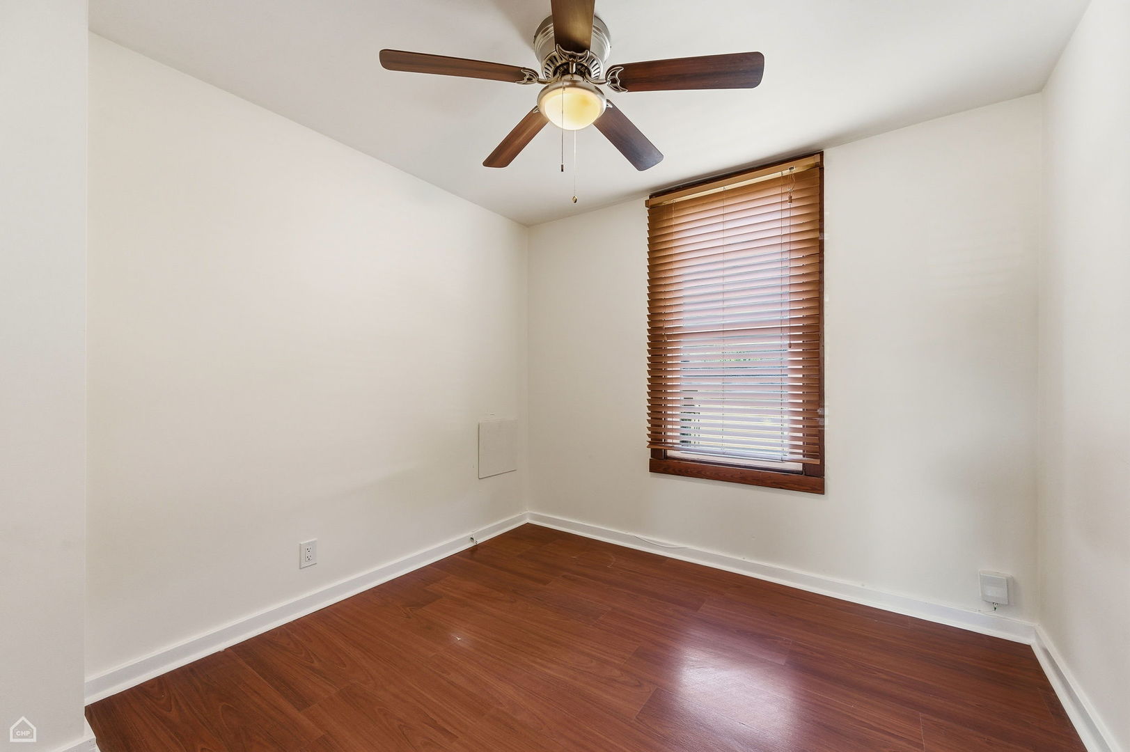 7635 West Foster Avenue Chicago, IL 60656 - Photo 11 of 24 an empty room with wooden floor chandelier fan and windows