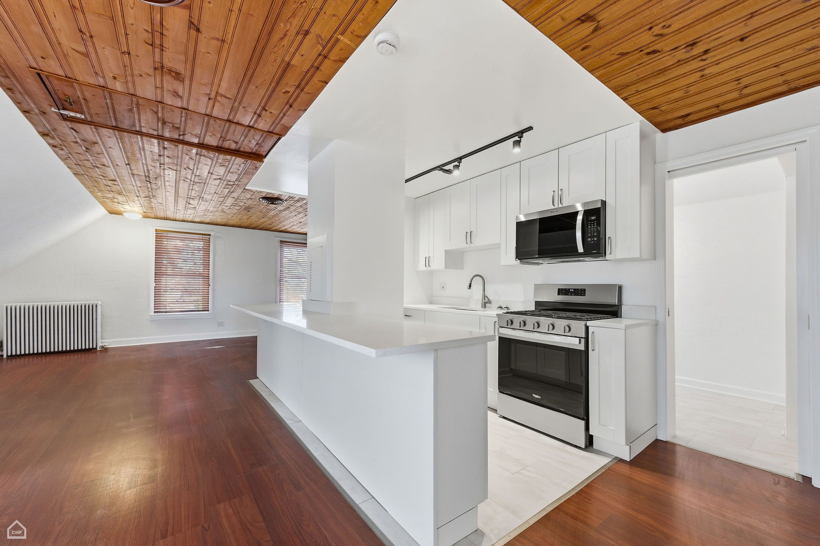 7635 West Foster Avenue Chicago, IL 60656 - Photo 13 of 24 a kitchen with stainless steel appliances a stove a sink and a microwave