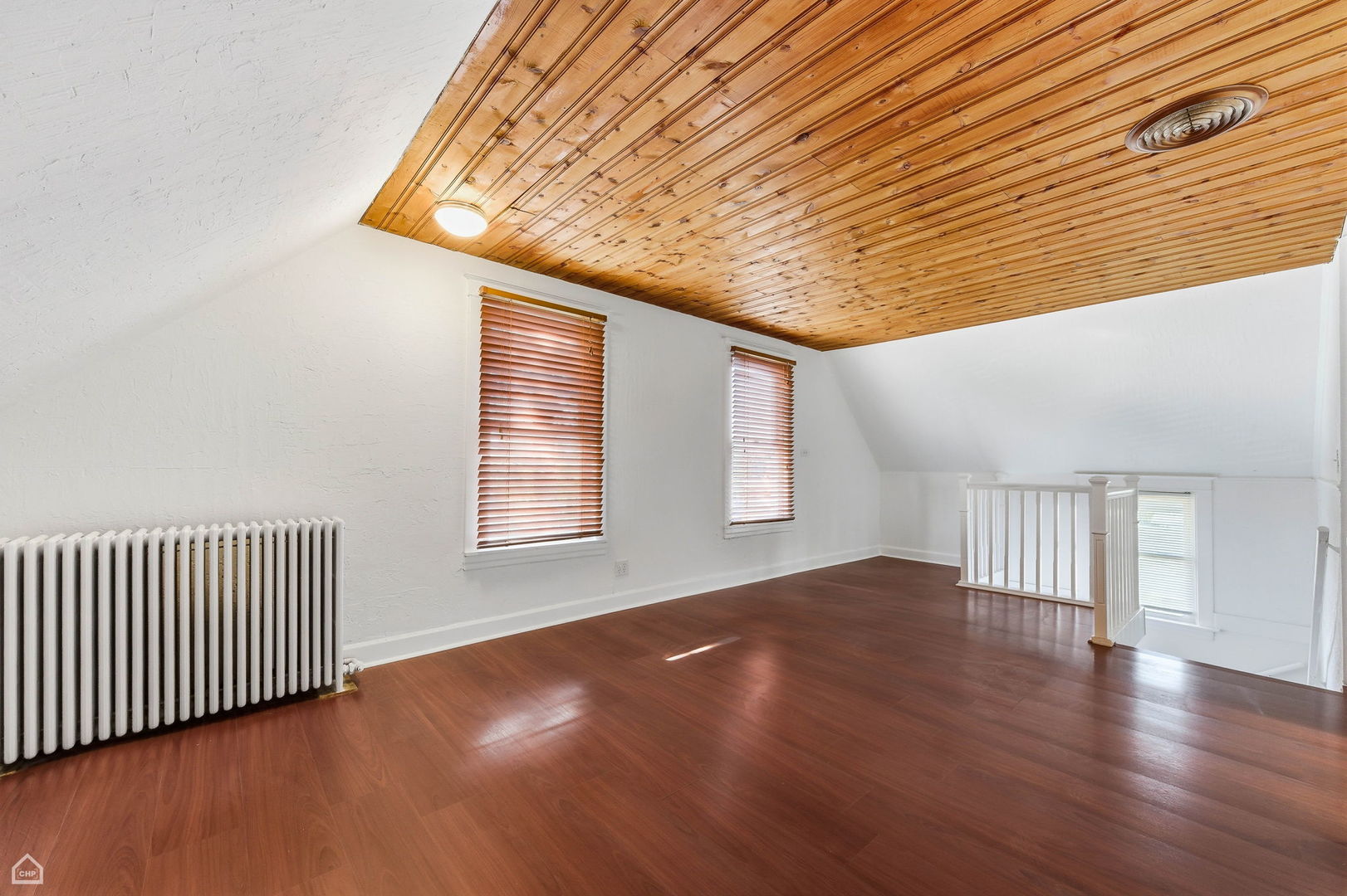 7635 West Foster Avenue Chicago, IL 60656 - Photo 18 of 24 an empty room with wooden floor and windows