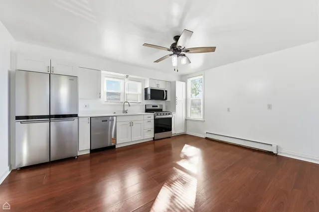 a view of kitchen with sink microwave and refrigerator