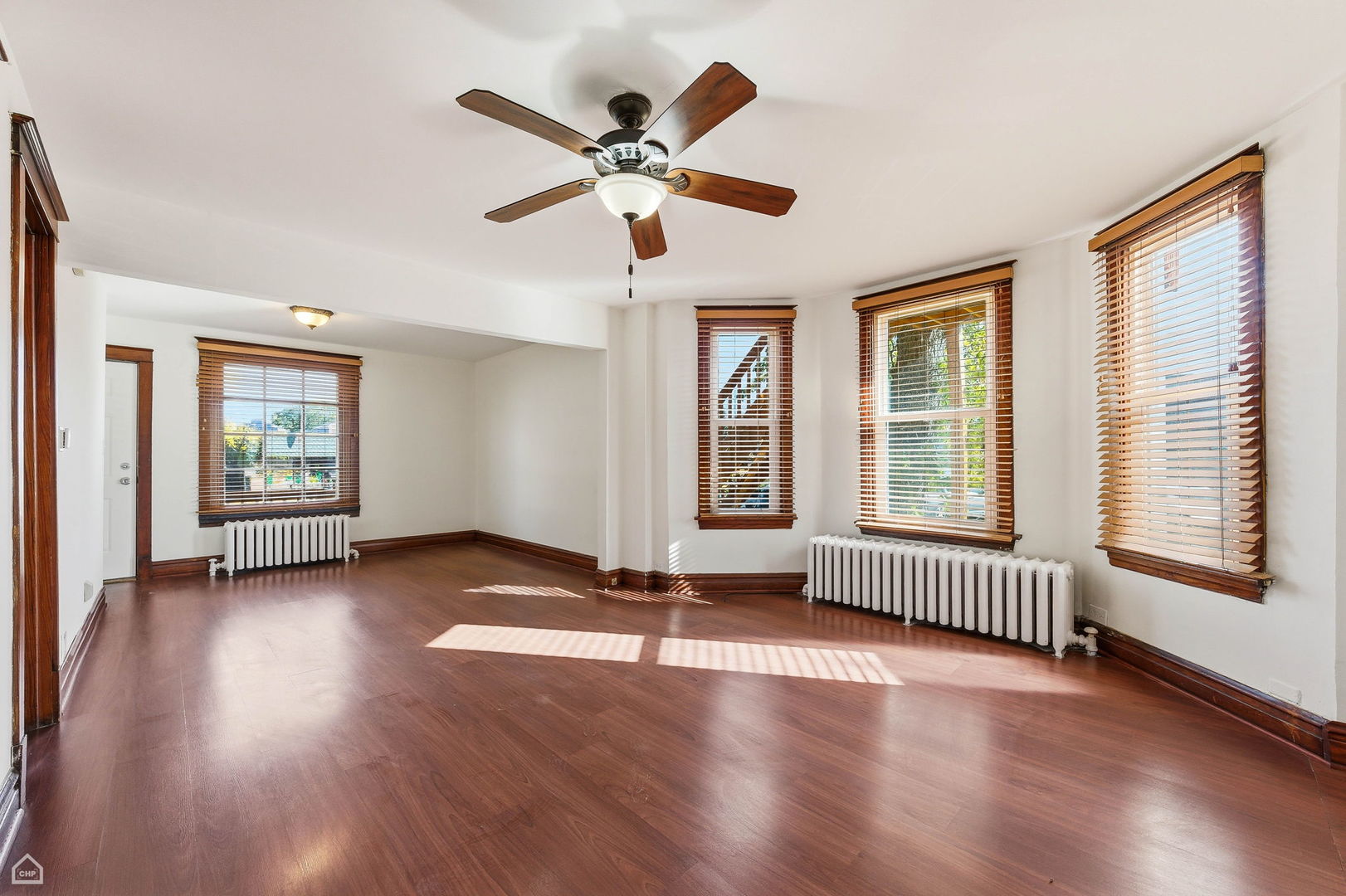 7635 West Foster Avenue Chicago, IL 60656 - Photo 9 of 24 a view of an empty room with wooden floor and a window