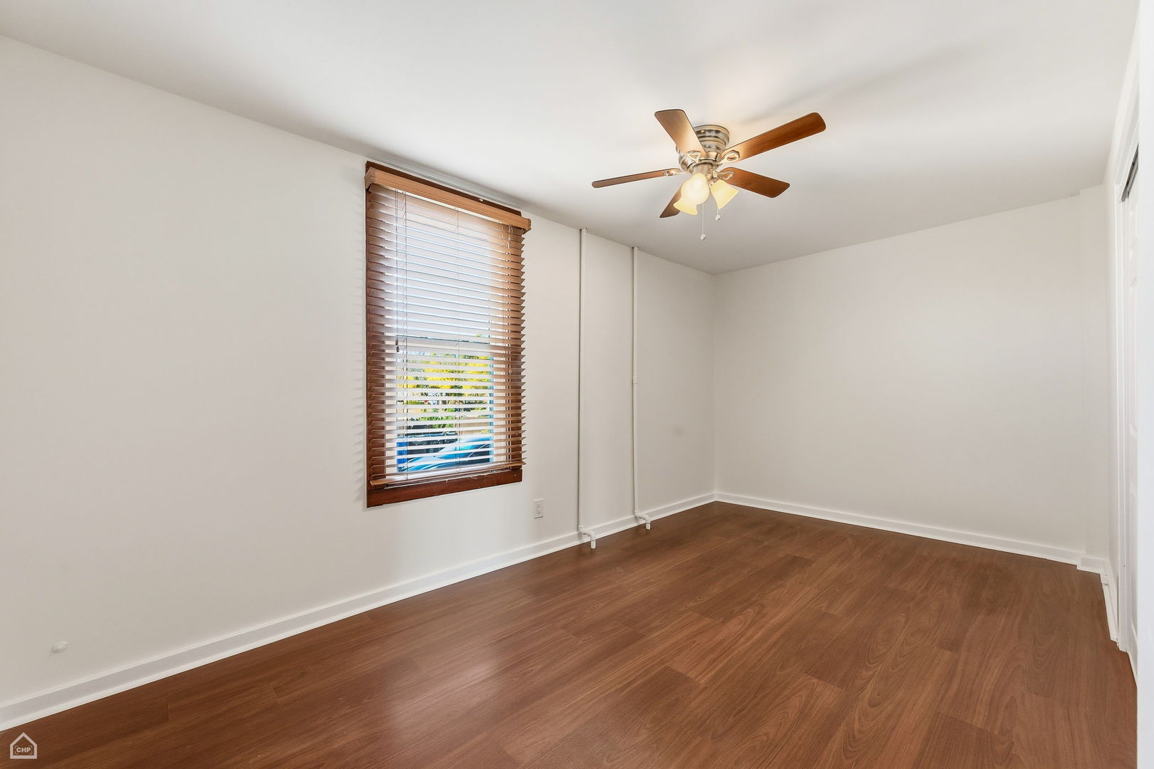 7635 West Foster Avenue Chicago, IL 60656 - Photo 10 of 24 a view of an empty room with window and wooden floor