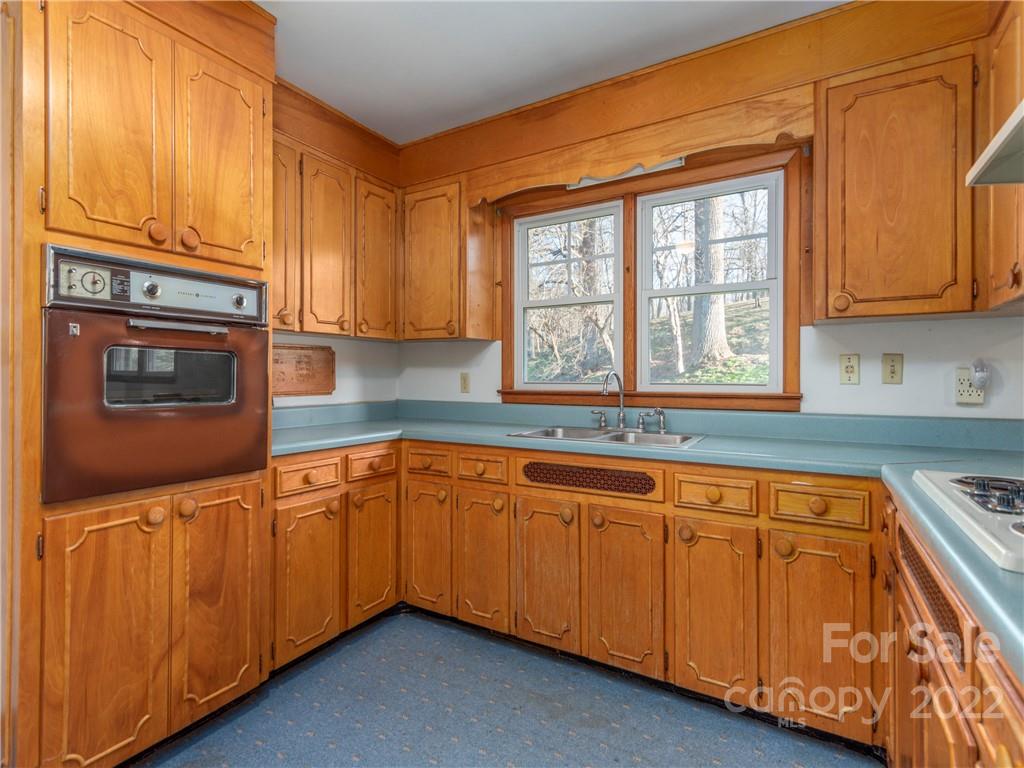 1179 Max Thompson Road Canton, NC 28716 - Photo 16 of 41 a kitchen with stainless steel appliances granite countertop a sink and a microwave