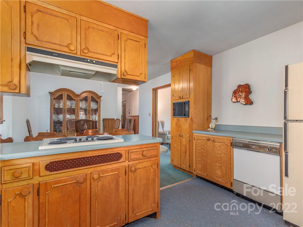 1179 Max Thompson Road Canton, NC 28716 - Photo 17 of 41 a view of a refrigerator a sink and cabinets