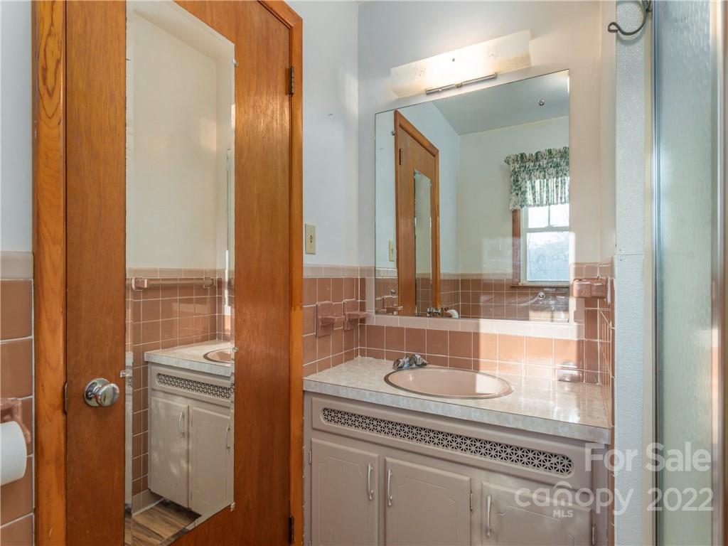 1179 Max Thompson Road Canton, NC 28716 - Photo 22 of 41 a bathroom with a granite countertop sink and a mirror