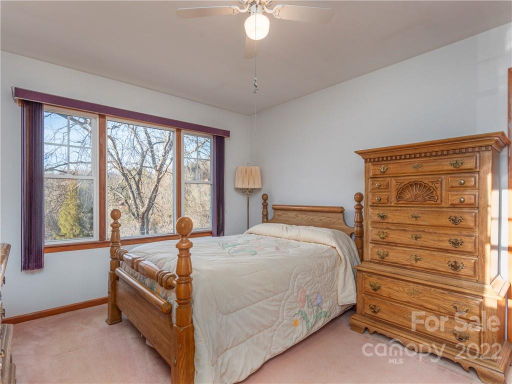1179 Max Thompson Road Canton, NC 28716 - Photo 23 of 41 a bed room with a bed and a window