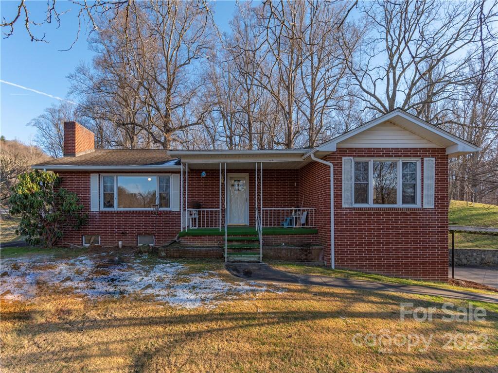 1179 Max Thompson Road Canton, NC 28716 - Photo 5 of 41 a front view of a house with garden