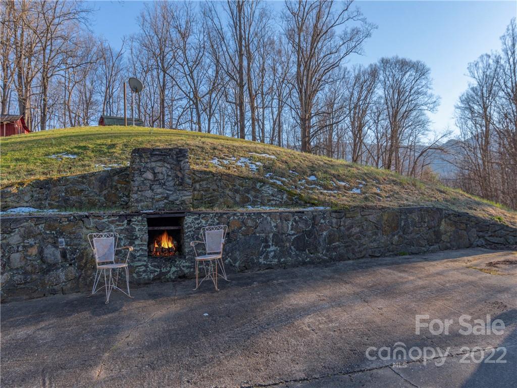 1179 Max Thompson Road Canton, NC 28716 - Photo 10 of 41 a view of a backyard with a barn and a fireplace