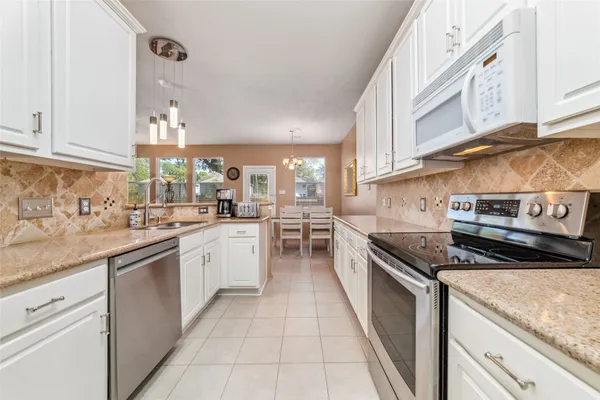 a kitchen with stainless steel appliances granite countertop a sink and stove