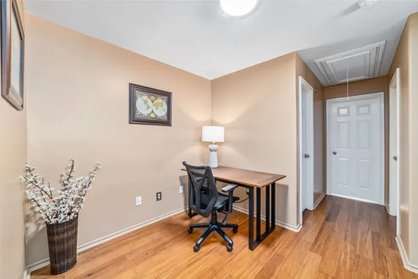 a view of a workspace with furniture and wooden floor