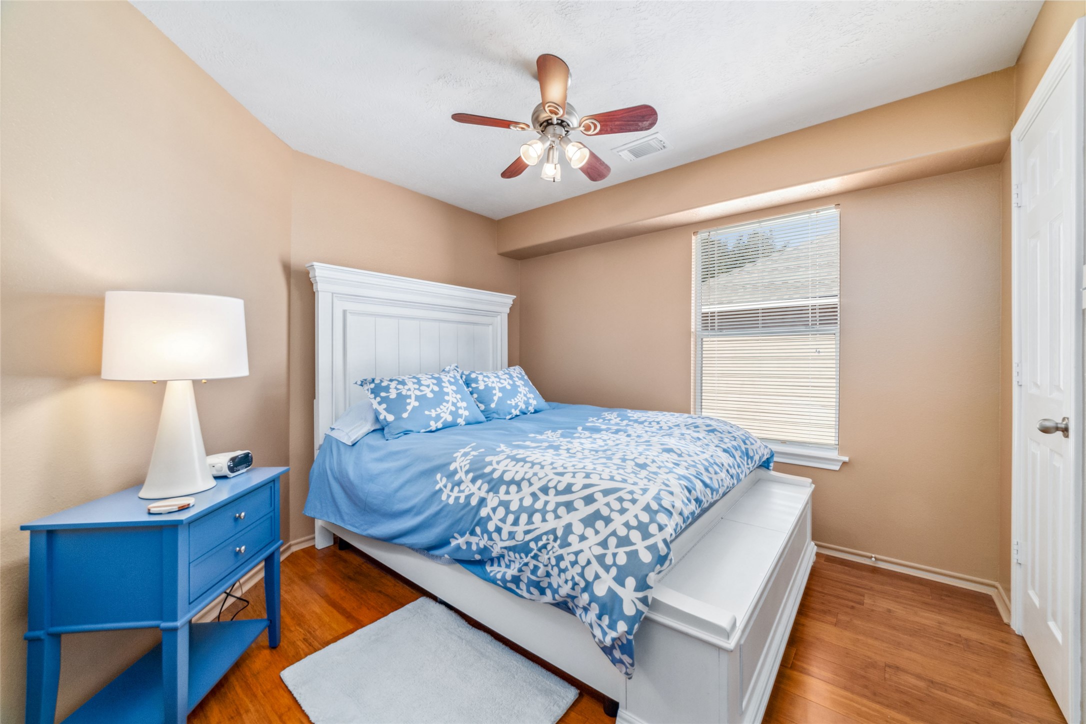 203 West Stedhill Loop Conroe, TX 77384 - Photo 21 of 45 a bed sitting in a bedroom next to a lamp