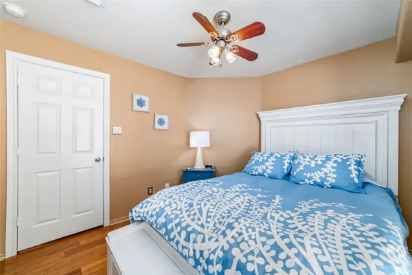 a bedroom with a bed and a painting on the wall