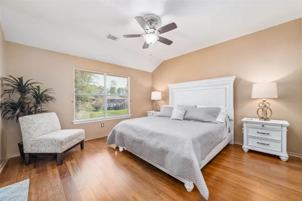 a bedroom with a large bed and a large window