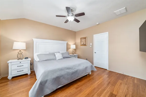 a bedroom with a bed and a night stand