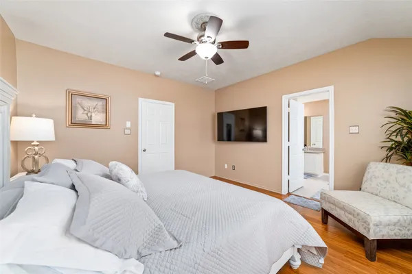 a bedroom with a large bed and a tv