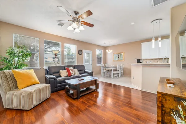 a living room with furniture and wooden floor