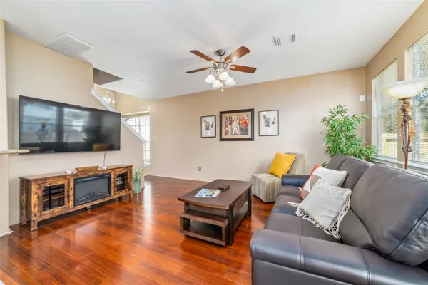 a living room with furniture and a flat screen tv