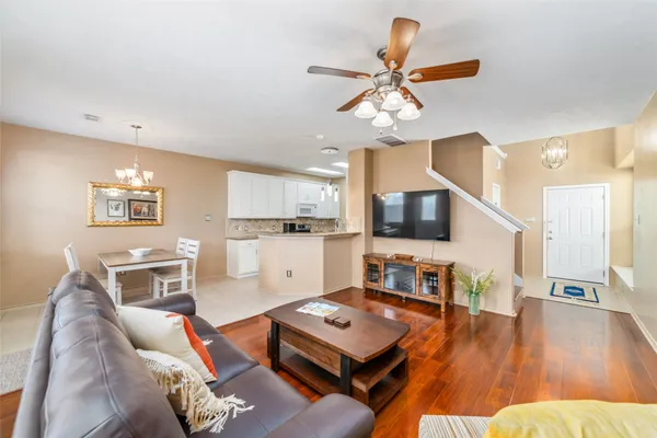 a living room with furniture and a wooden floor