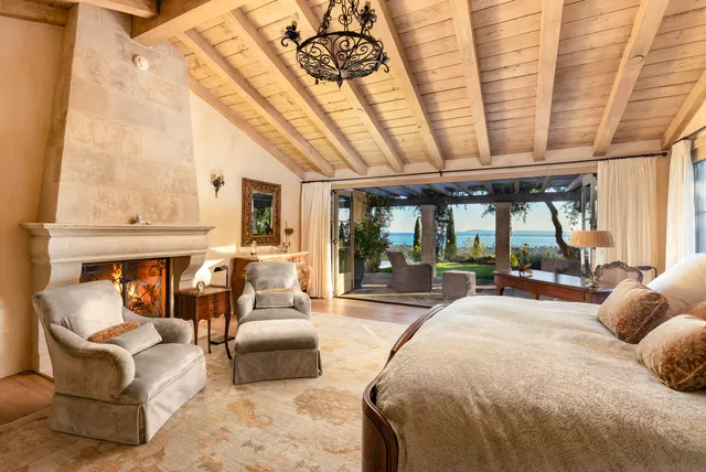 a large bedroom with furniture and large windows