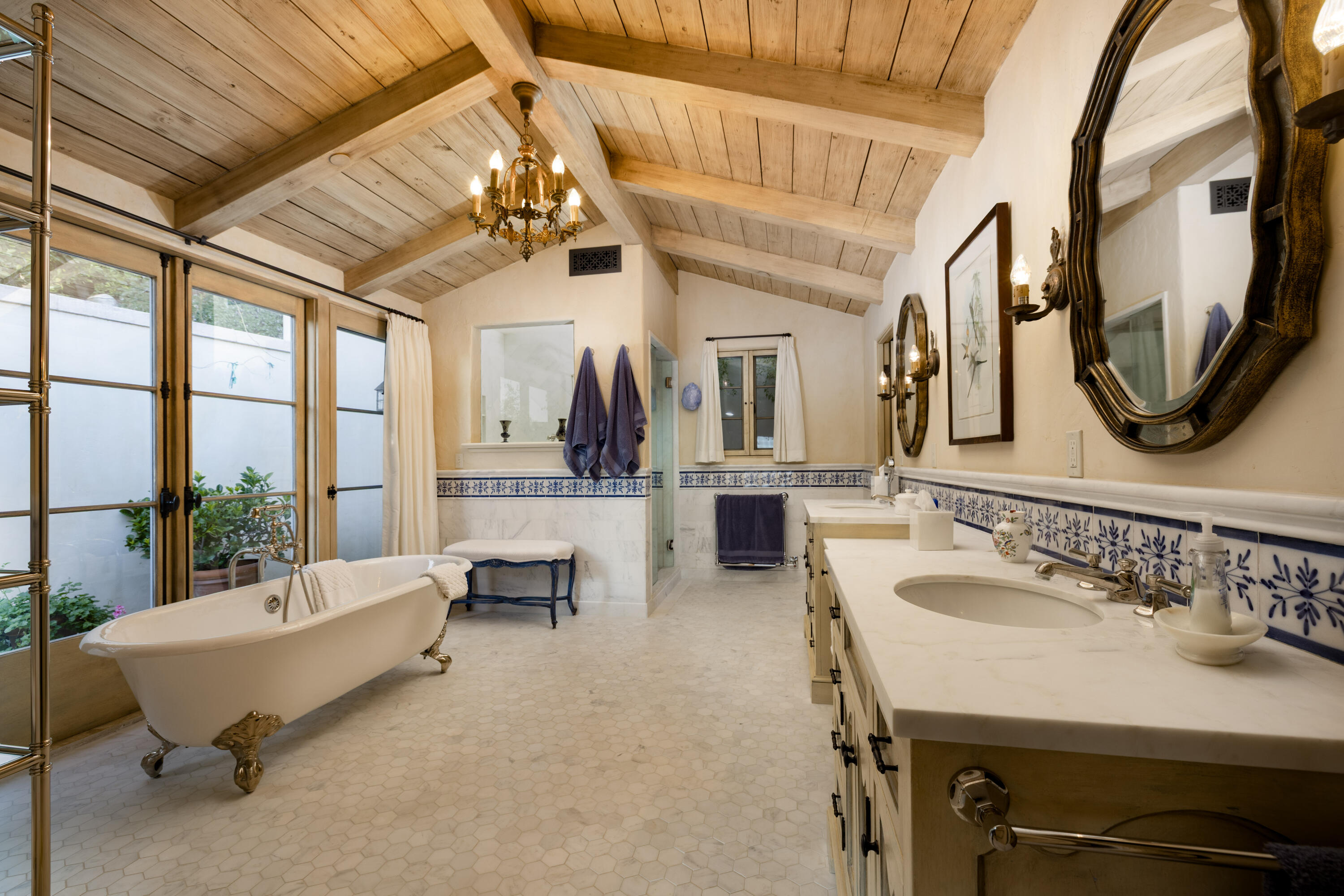 965 Brooktree Road Montecito, CA 93108 - Photo 14 of 26 a spacious bathroom with a table chairs and a mirror