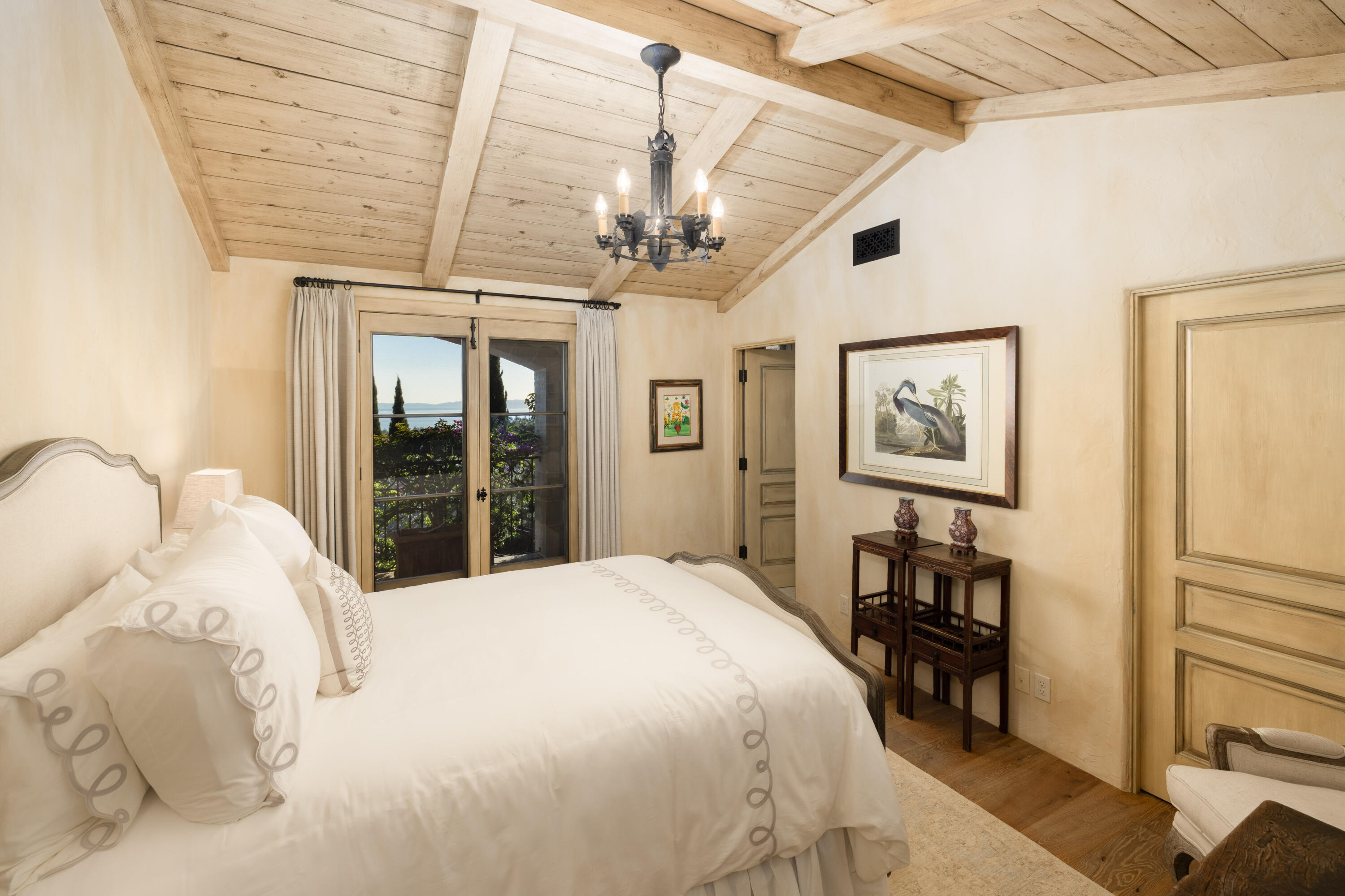 965 Brooktree Road Montecito, CA 93108 - Photo 15 of 26 a bedroom with a large bed and a chandelier