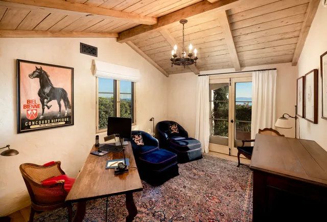 a living room with furniture a flat screen tv and a table