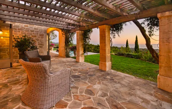 a view of a porch with furniture and garden